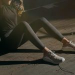 a woman sitting on the ground with her legs crossed
