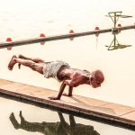 a person standing next to a body of water