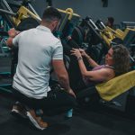 A man and a woman working out in a gym