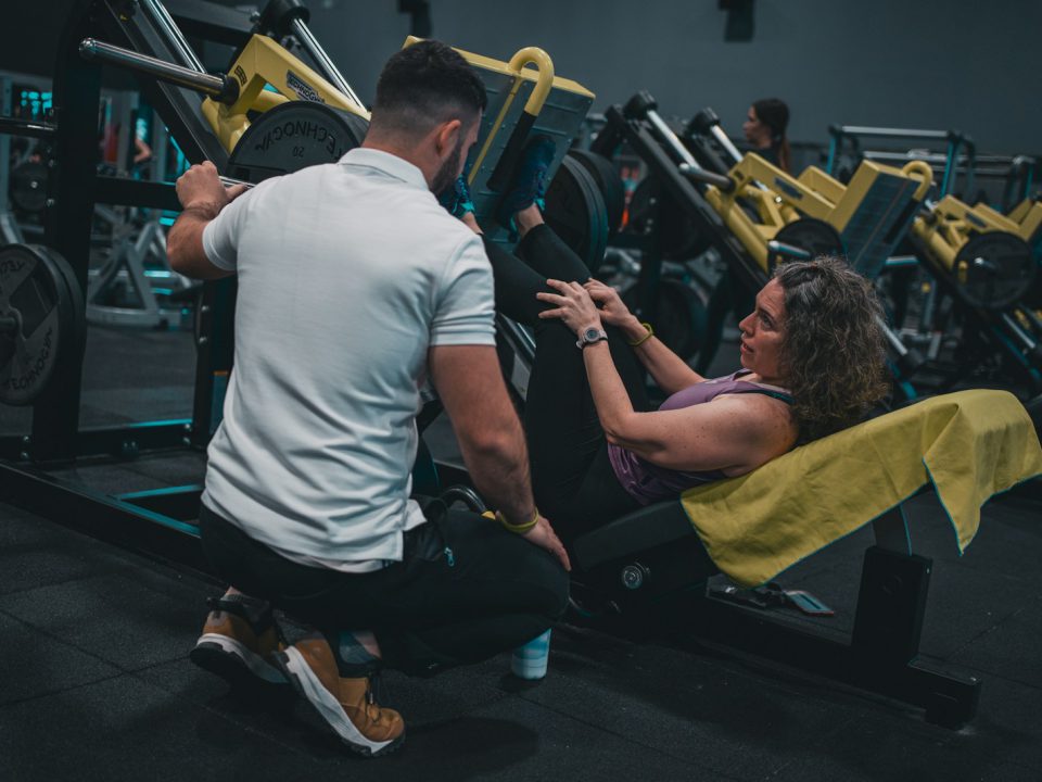 A man and a woman working out in a gym