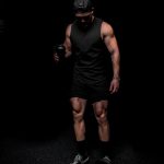 man in black tank top and shorts wearing black mask