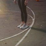 a person standing on a basketball court with a ball