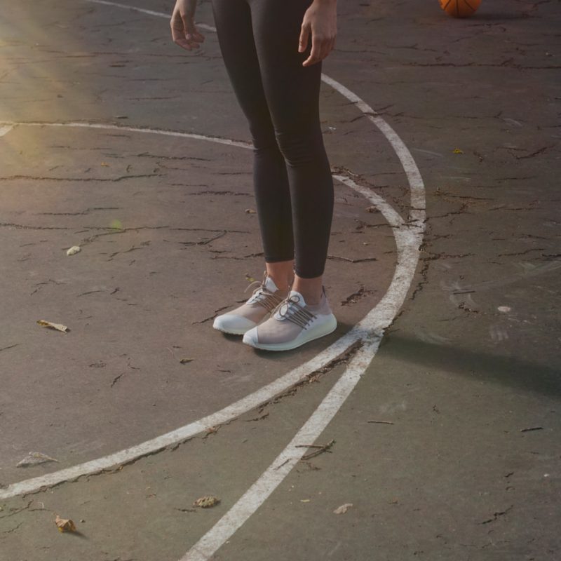 a person standing on a basketball court with a ball