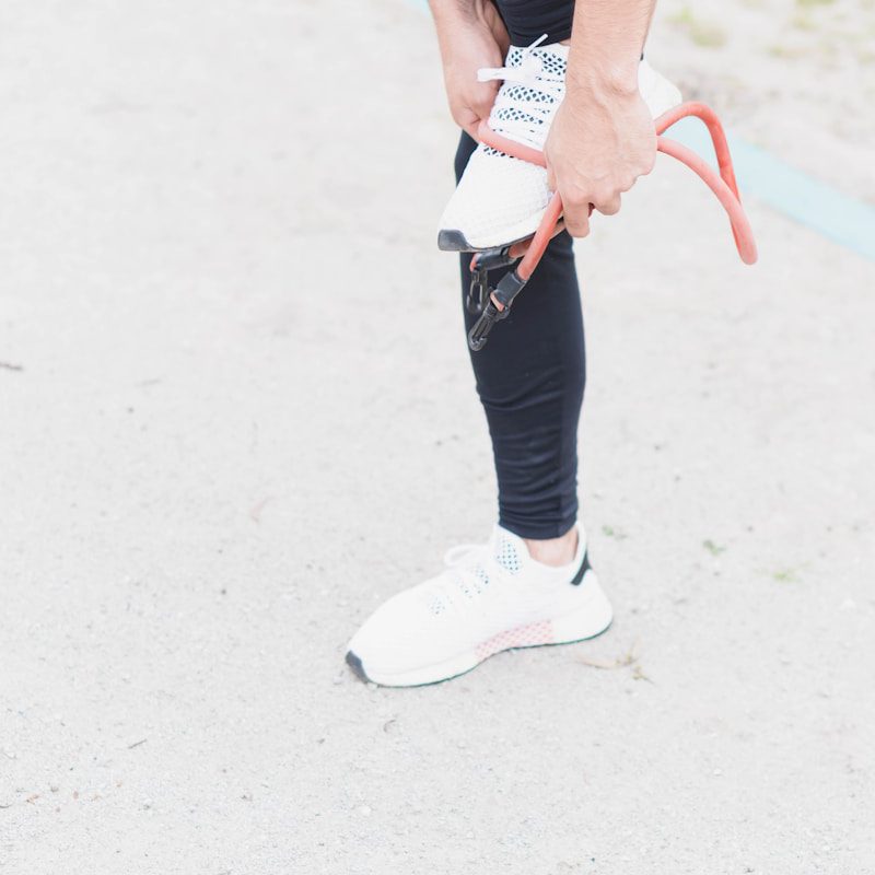 woman in white and black nike sneakers