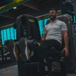 A man sitting on a bench in a gym