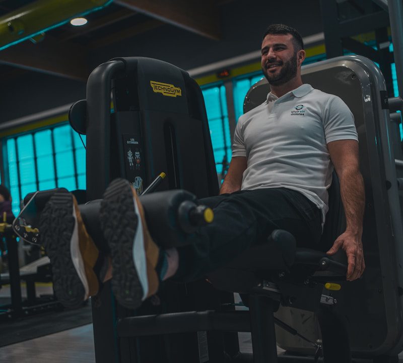 A man sitting on a bench in a gym
