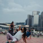 a woman laying on the ground taking a picture with her cell phone