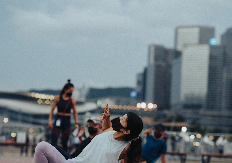 a woman laying on the ground taking a picture with her cell phone