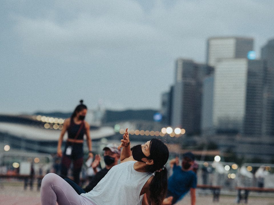 a woman laying on the ground taking a picture with her cell phone